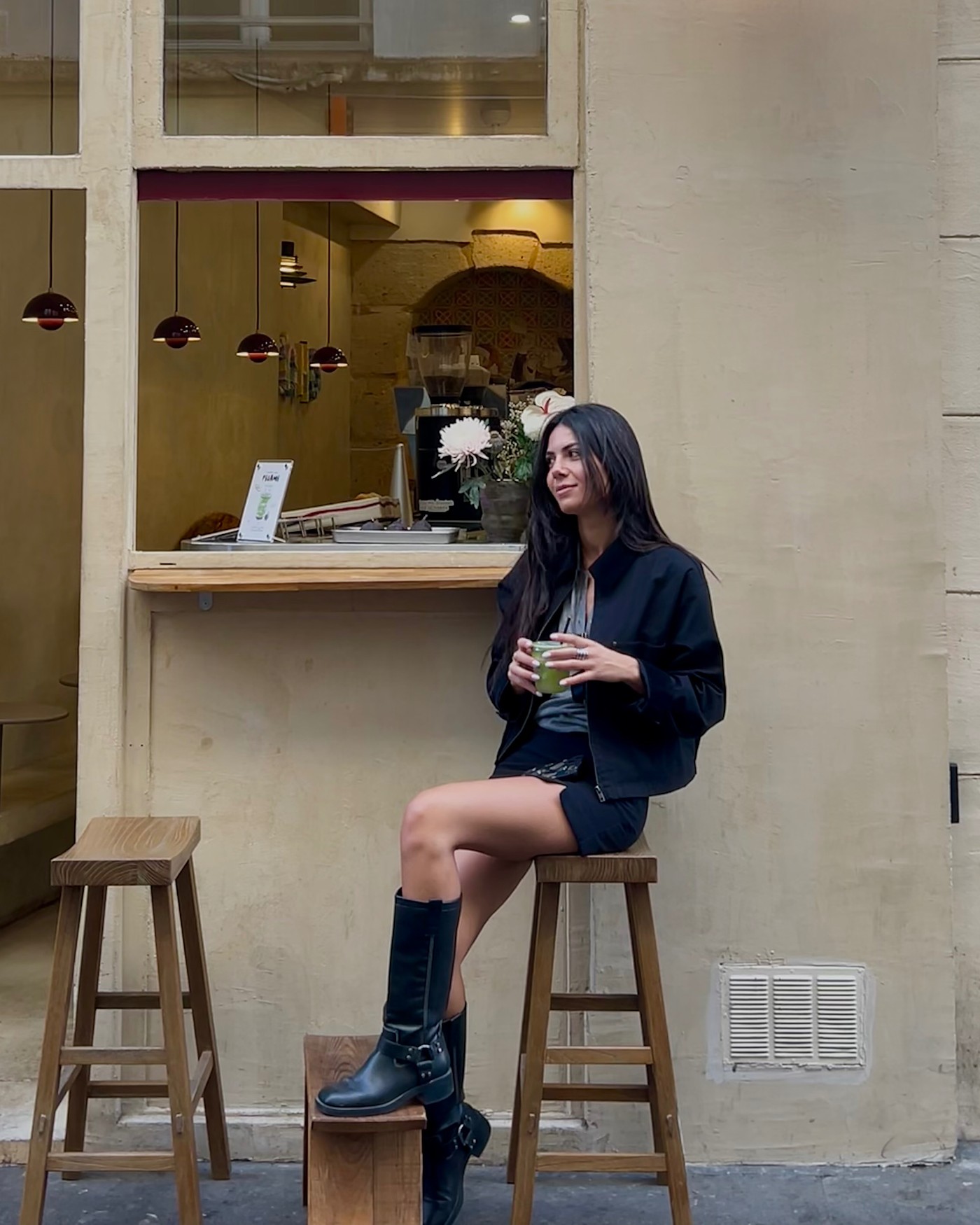 Christina sitting outside a coffee shop