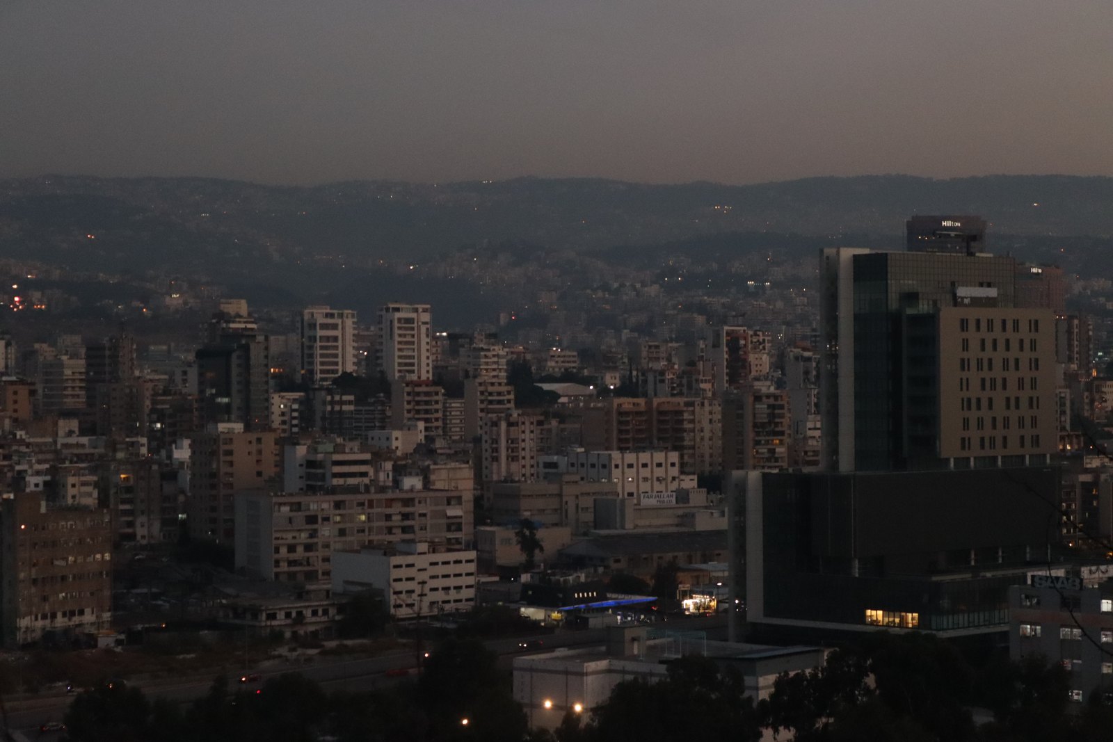 Beirut cityscape at dusk with only a few lit windows