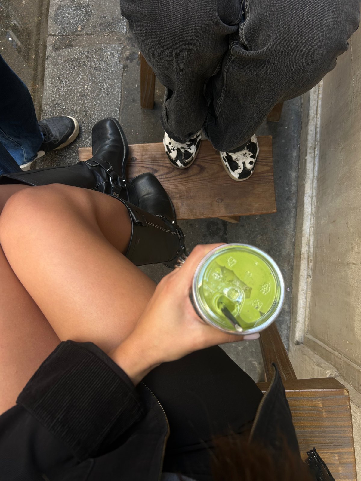 Iced matcha in hand at a café terrace